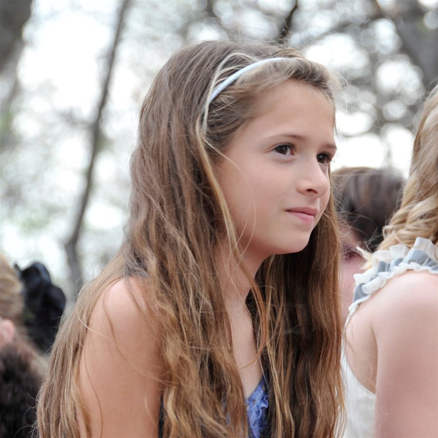 Sydney Reece Bjornberg outdoors, wearing a headband and smiling softly