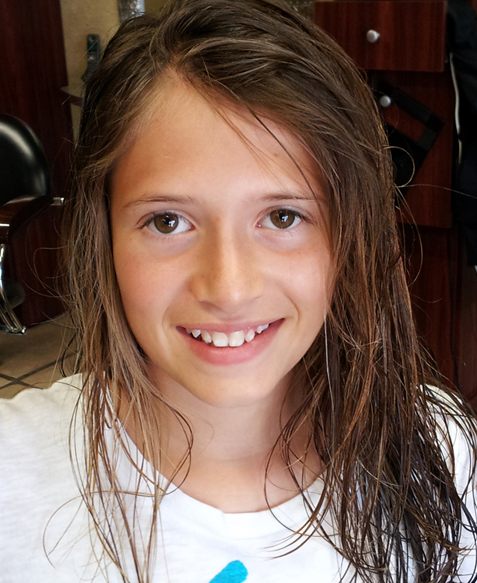 Sydney smiling at the camera